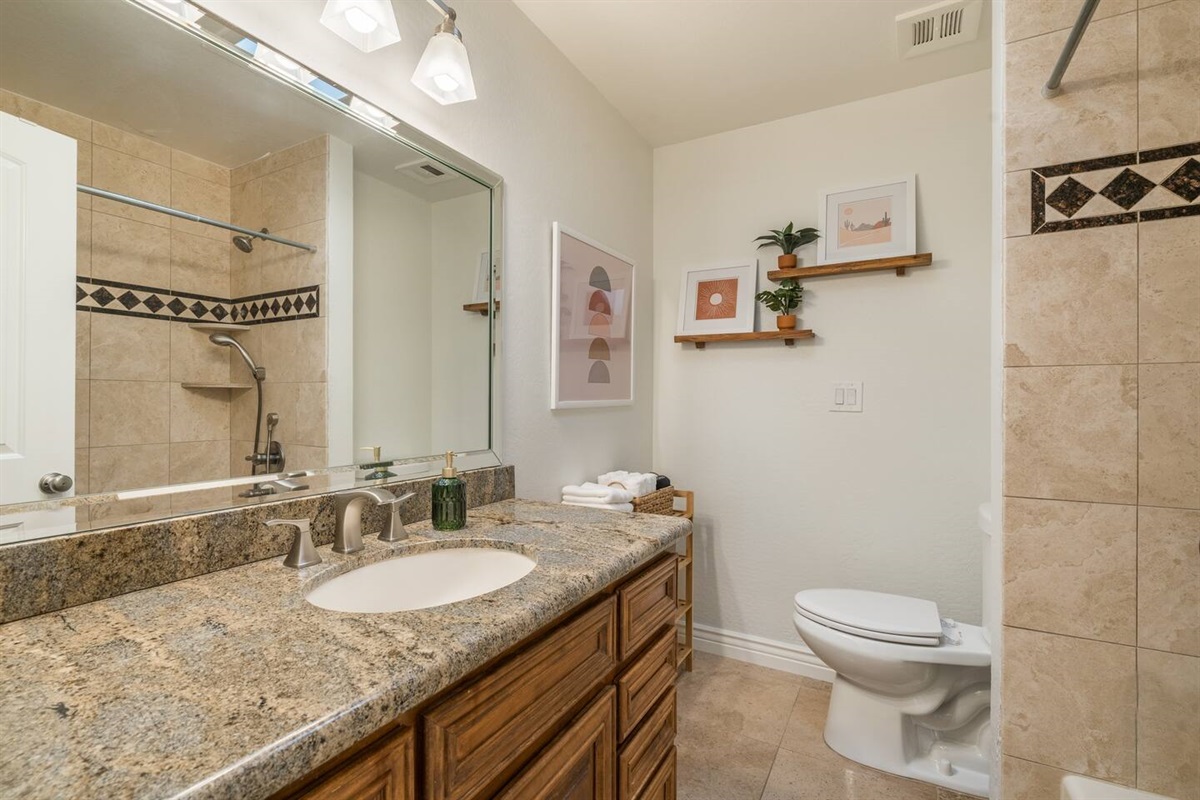 Hall bathroom has a tub/shower.