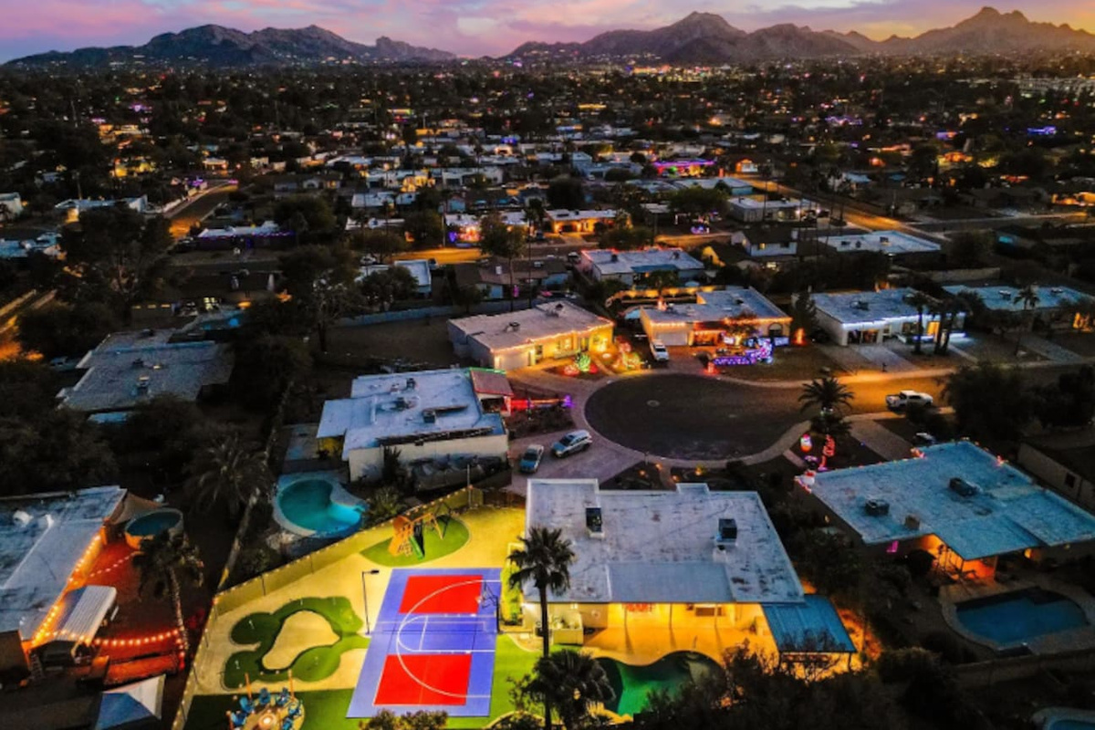 Camelback Mountain on the horizon, string lights below — Scottsdale views most guests only see from a rooftop bar.
