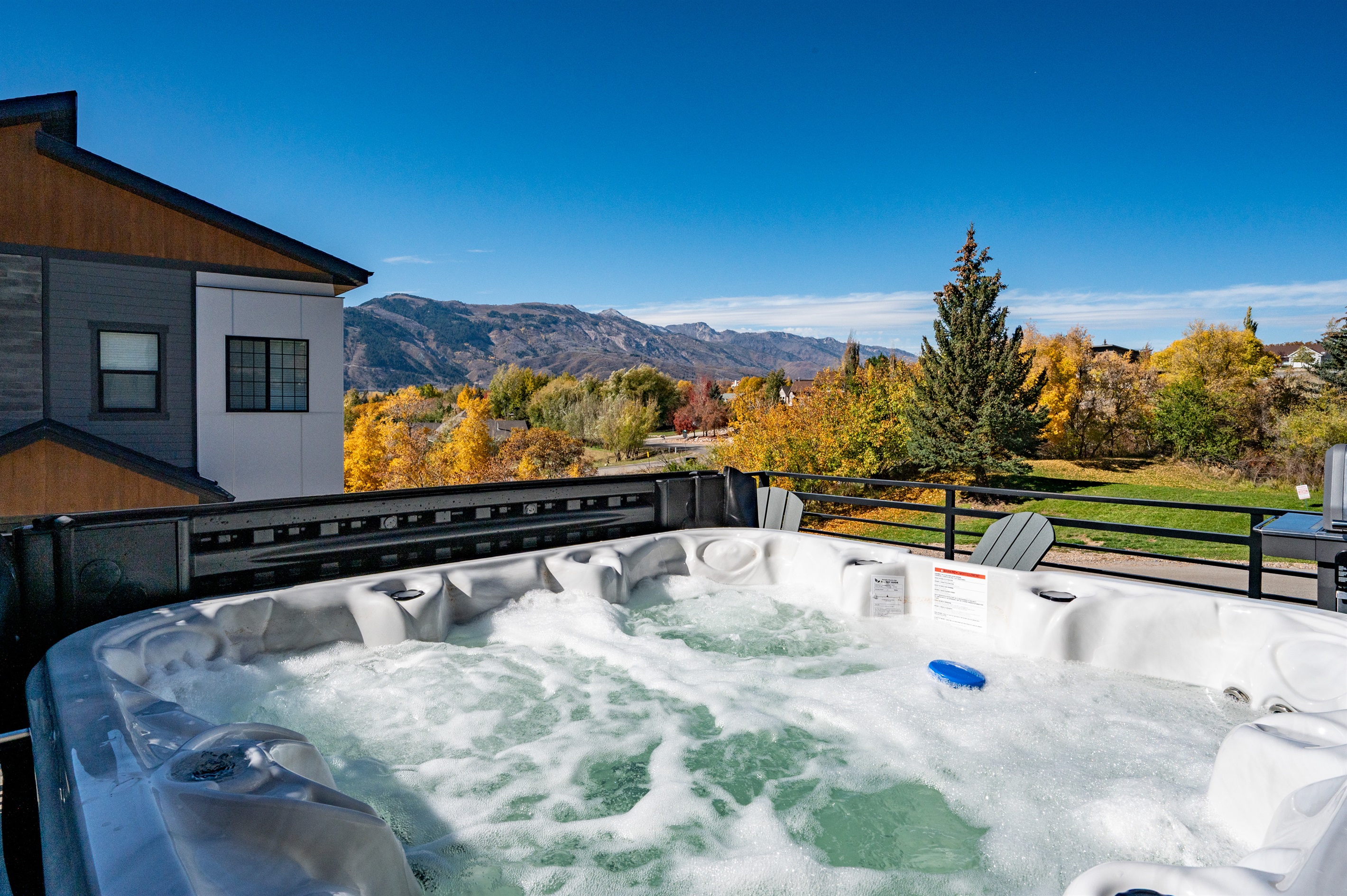 Private hot tub with panoramic mountain views for year-round relaxation.
