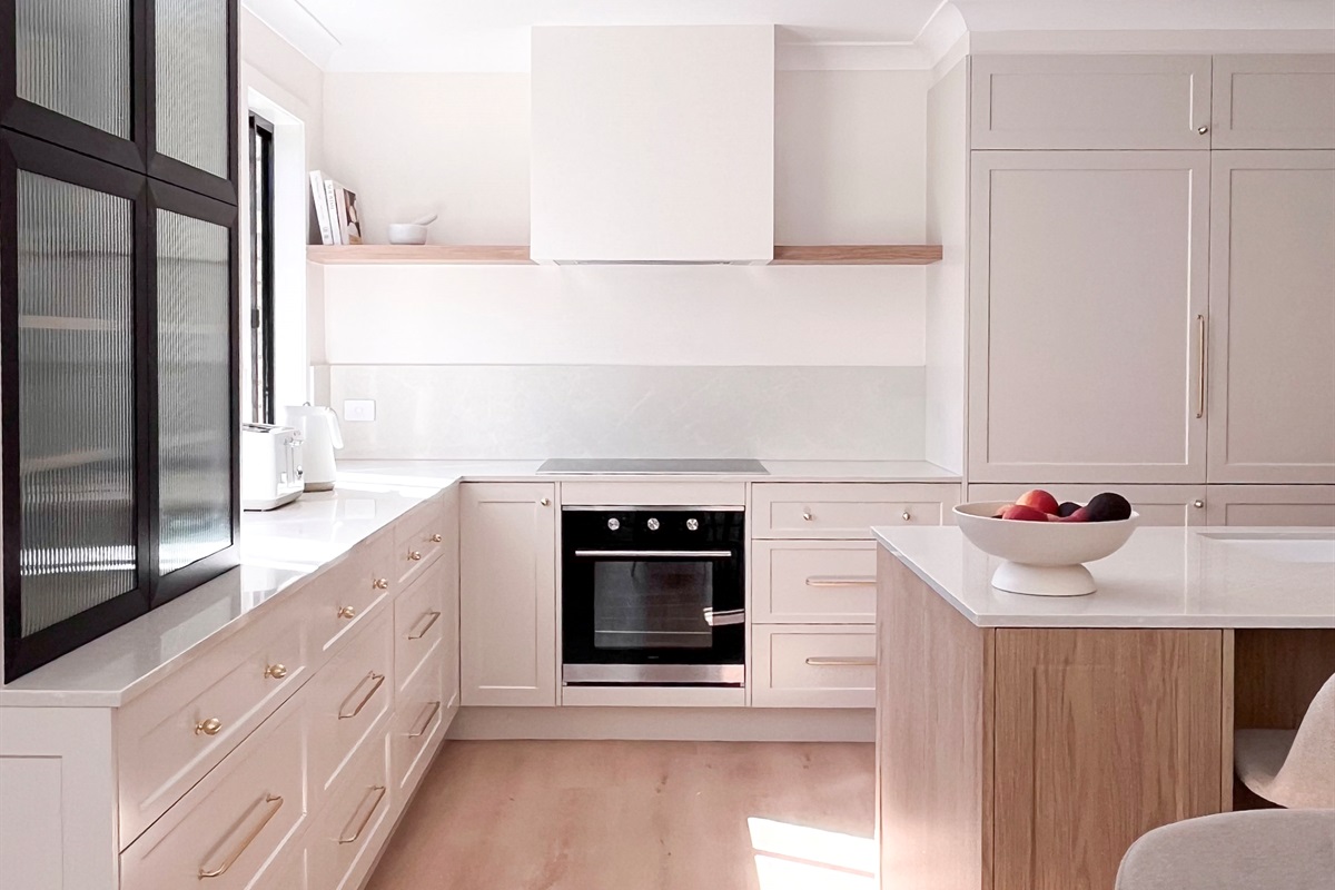 Tall storage, wide drawers and a central island give the kitchen practical space for longer stays and meal preparation.
