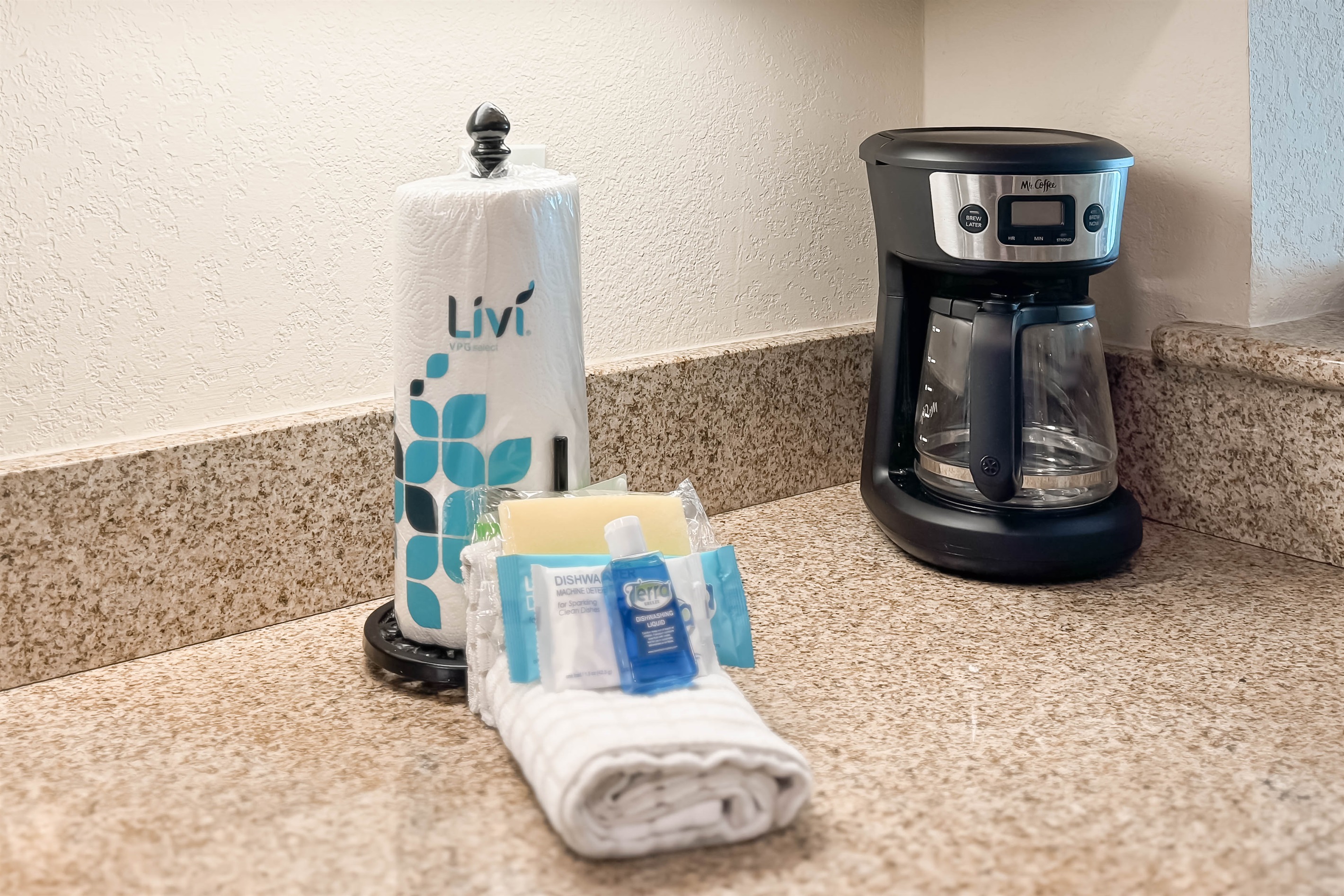 Modern kitchen essentials at your fingertips. This countertop setup offers everything you need for a quick breakfast or a relaxing cup of coffee.