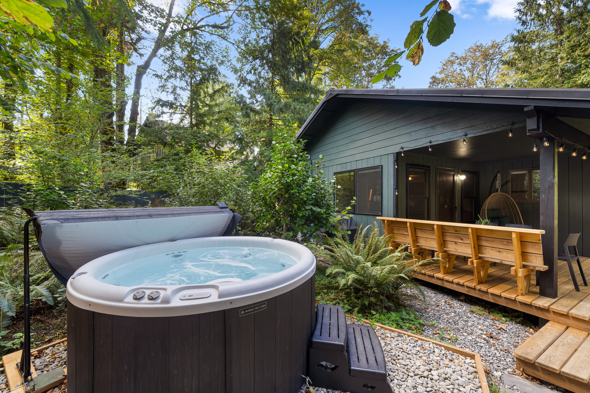 Steps from the deck, your private hot tub waits in its own little forest nook.