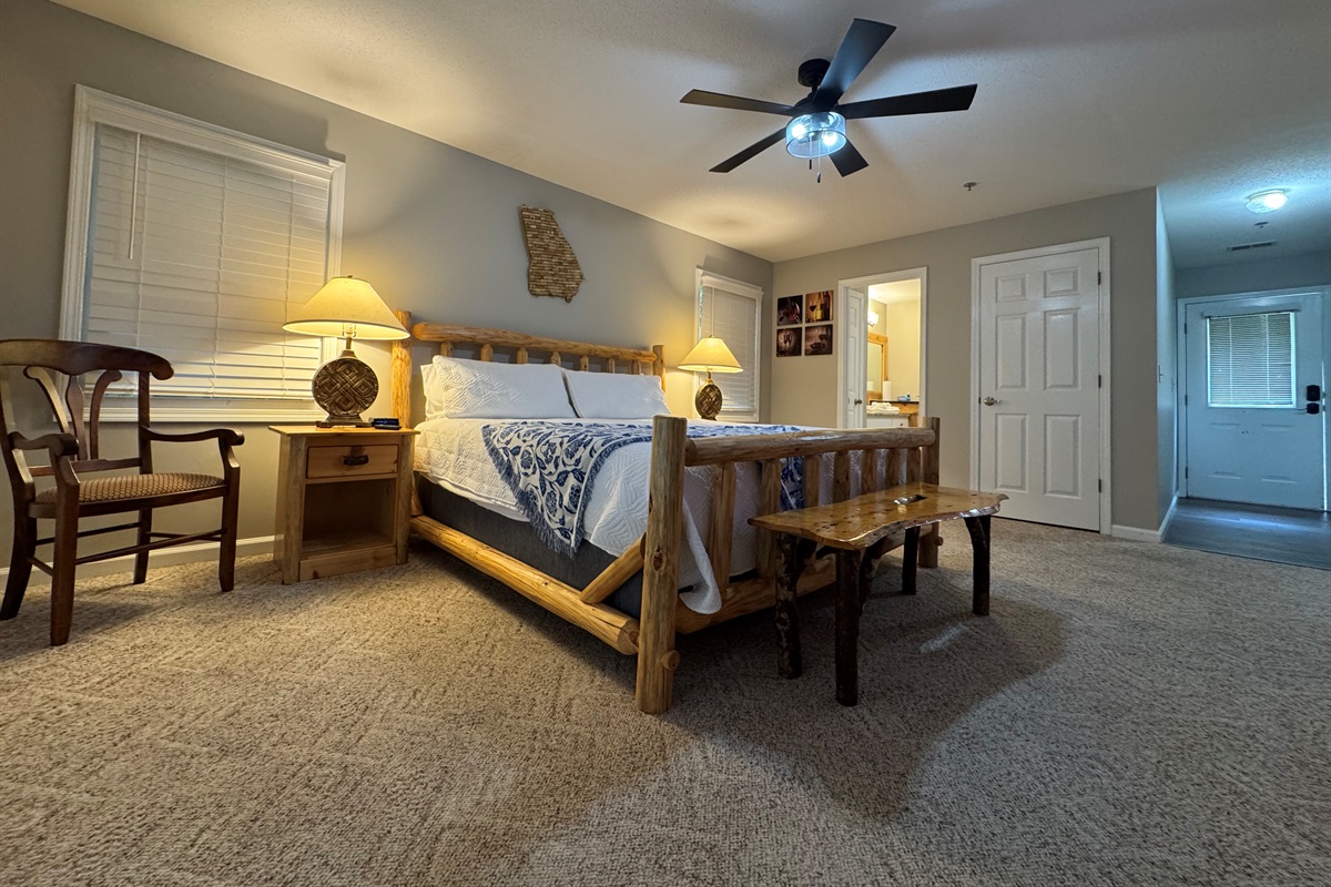 Relax in rustic comfort with a king-size bed, soft lighting, and cozy cabin charm. Step right out onto your private deck and enjoy the peaceful tree-lined views.