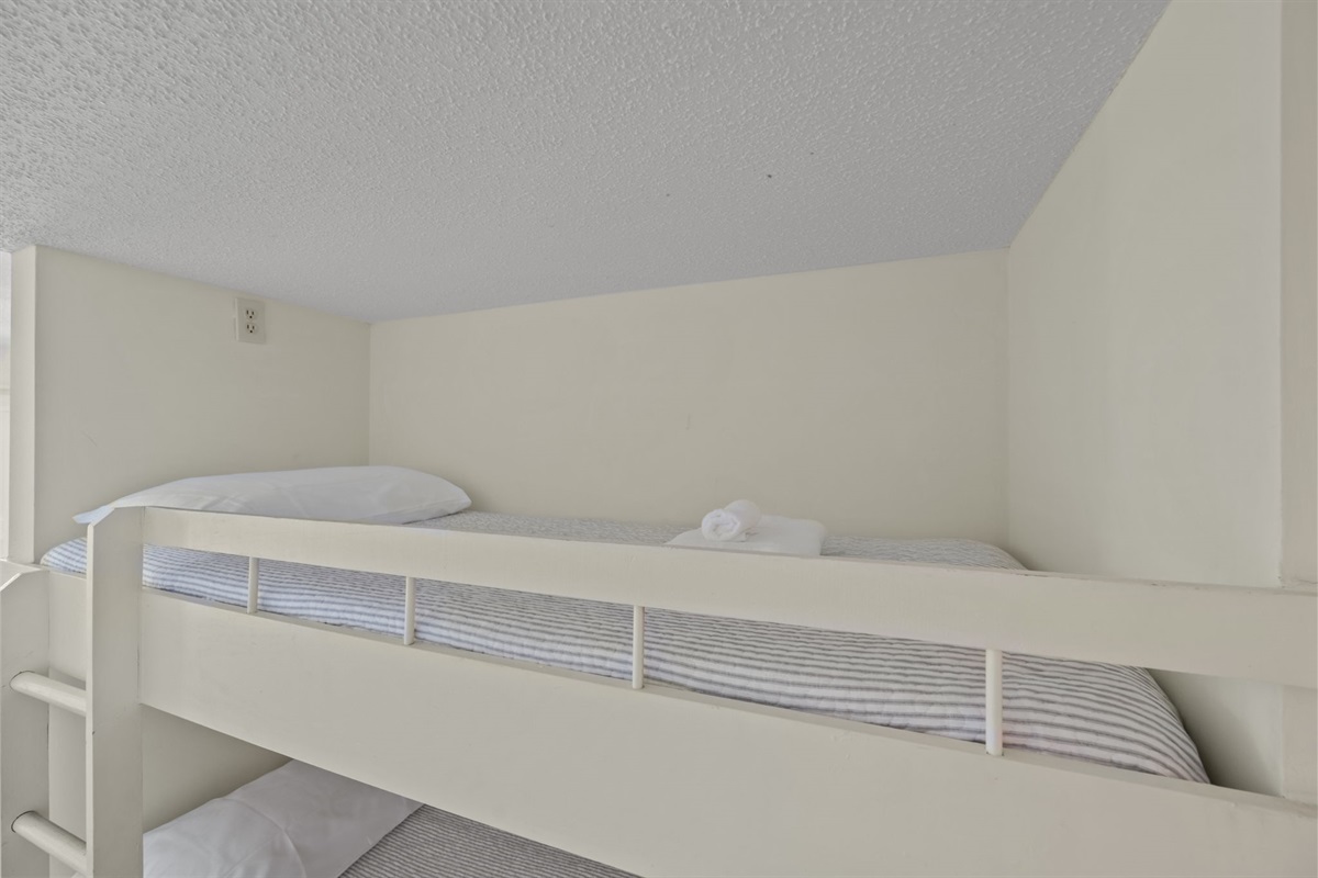 Top bunk provides a snug, private sleep spot, perfect for kids or extra guests, with built-in rails for peace of mind