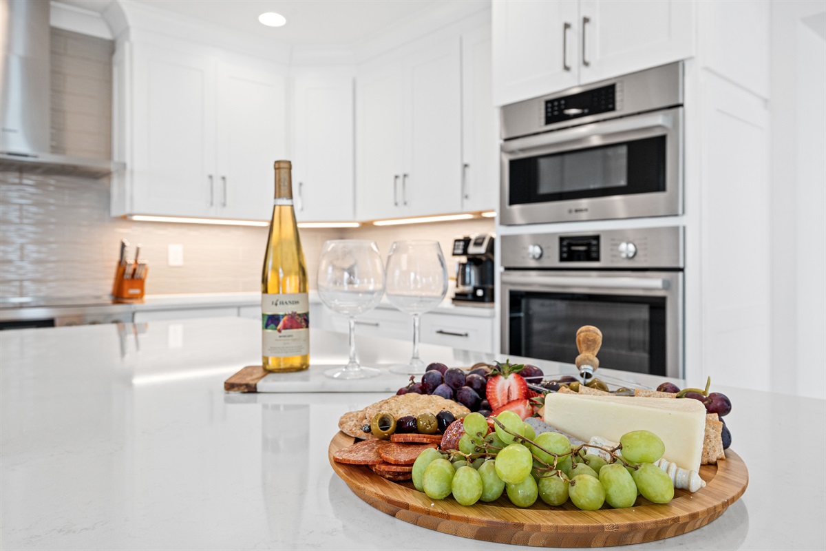 Bright gourmet kitchen with sleek finishes, premium appliances, and plenty of space for preparing meals and entertaining your group
