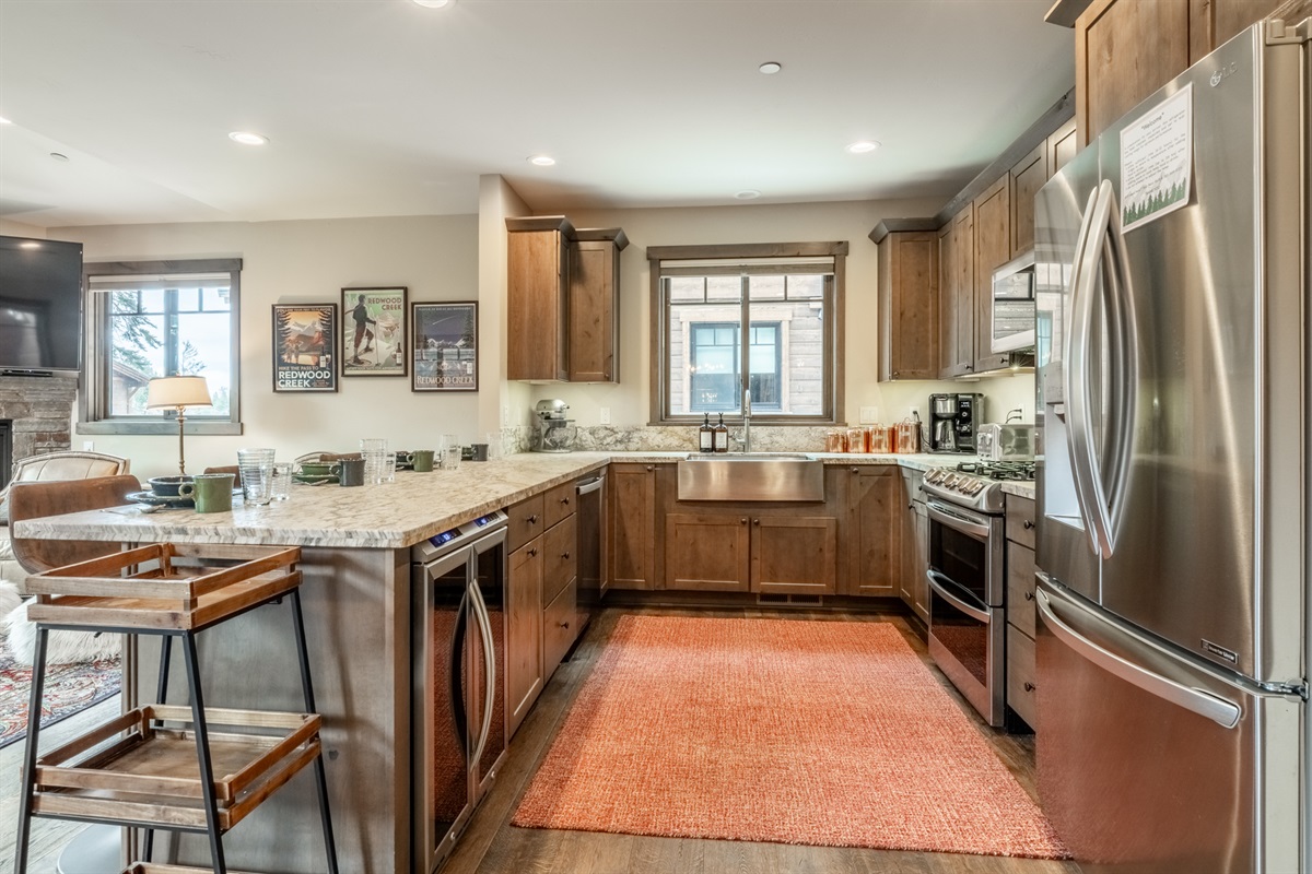 Apogee’s gourmet kitchen features dual ovens, gas range, custom cabinetry, and generous prep space.
