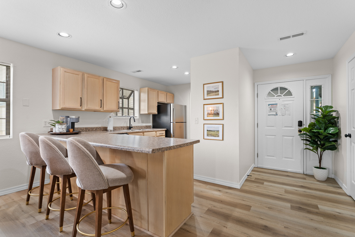 Three counter stools provide casual seating for breakfast, coffee, or conversation while cooking.