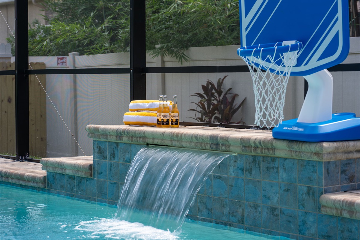 With a crystal-clear pool, waterfall feature, and basketball hoop, this space is perfect for both relaxation and family-friendly fun.
