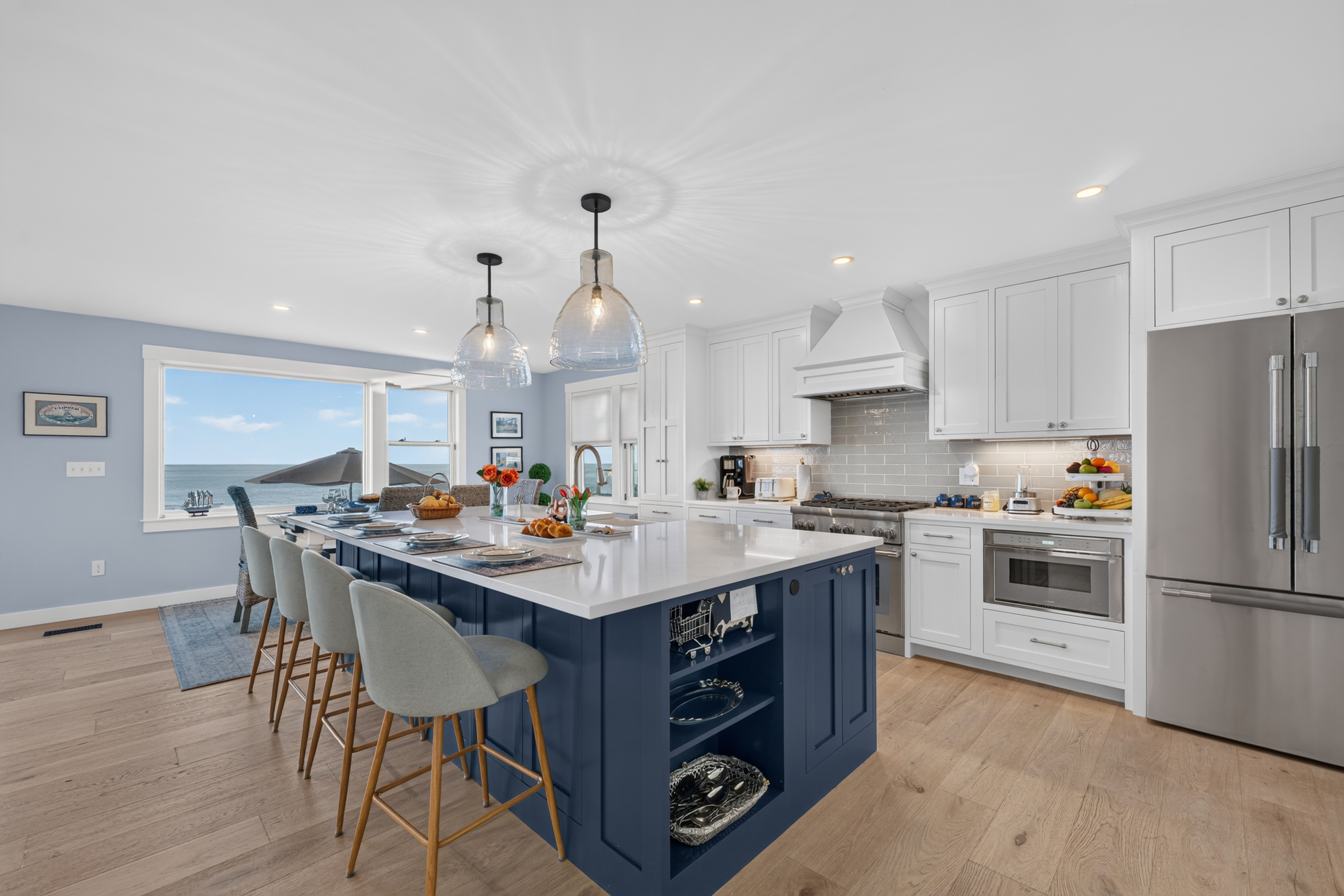 Spacious gourmet kitchen with a large island, premium appliances, and ocean views