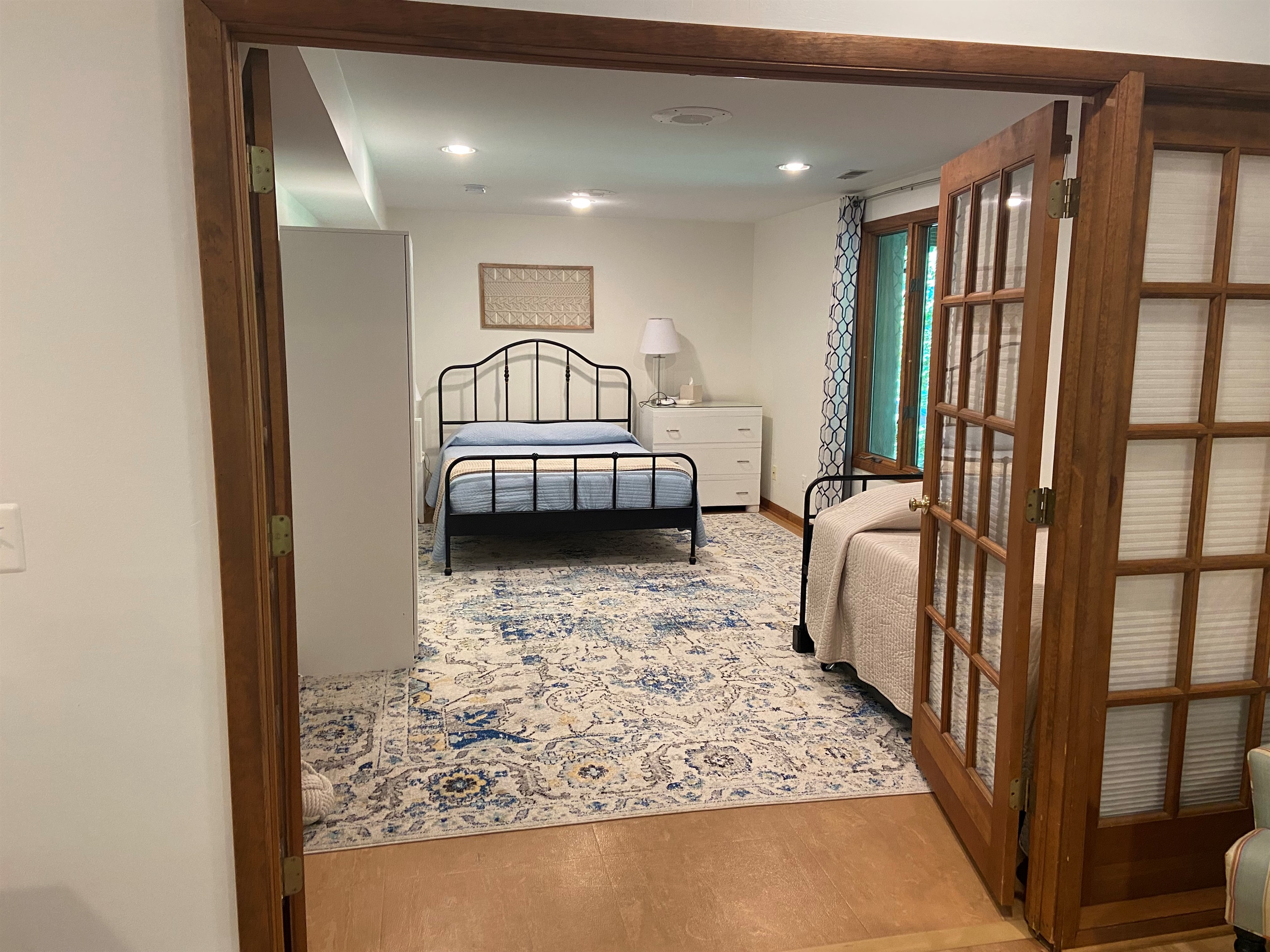 Spacious bedroom includes a queen bed and twin trundle.