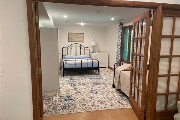 Spacious bedroom includes a queen bed and twin trundle.