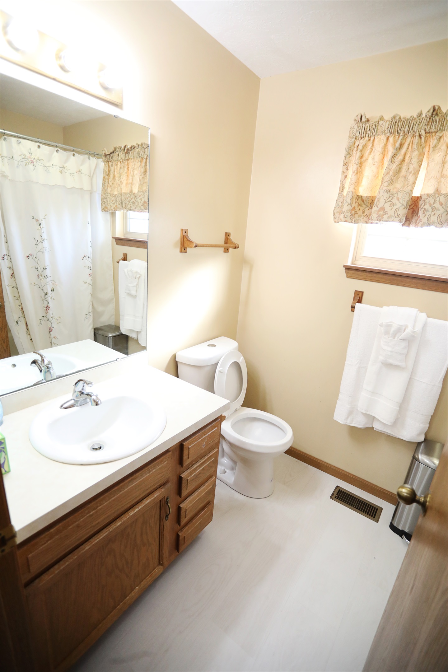 Second full bathroom showing sink, toilet, shower/tub to the right