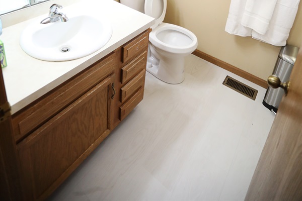 Second full bathroom showing sink, toilet, shower/tub to the right