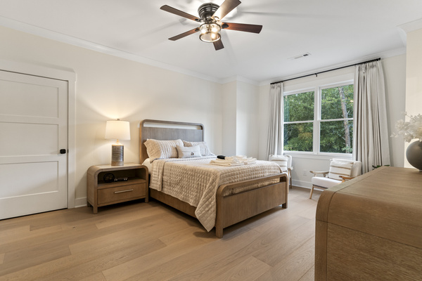 Queen bedroom with view of the backyard and pool with attached bathroom.