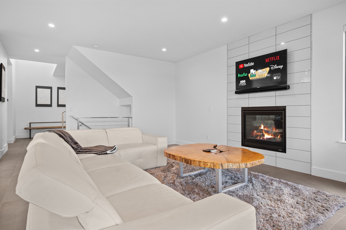 Comfortable main-level living room with electric fireplace and Smart TV for cozy evenings in.