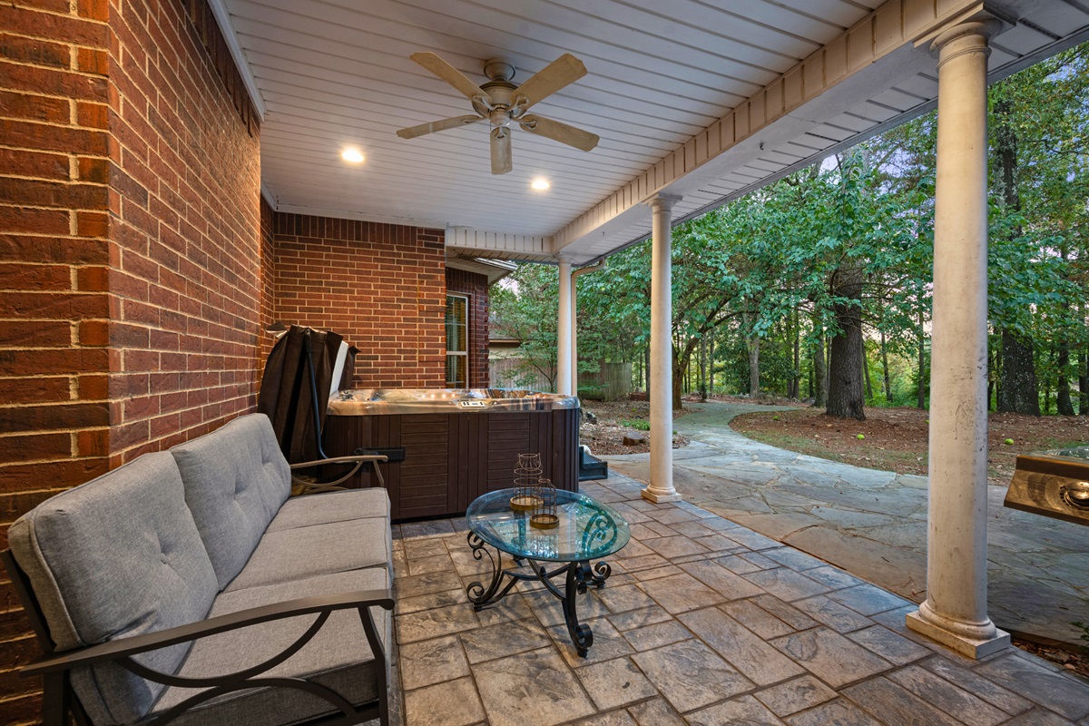 Covered patio with comfortable lounge furniture for outdoor relaxation.