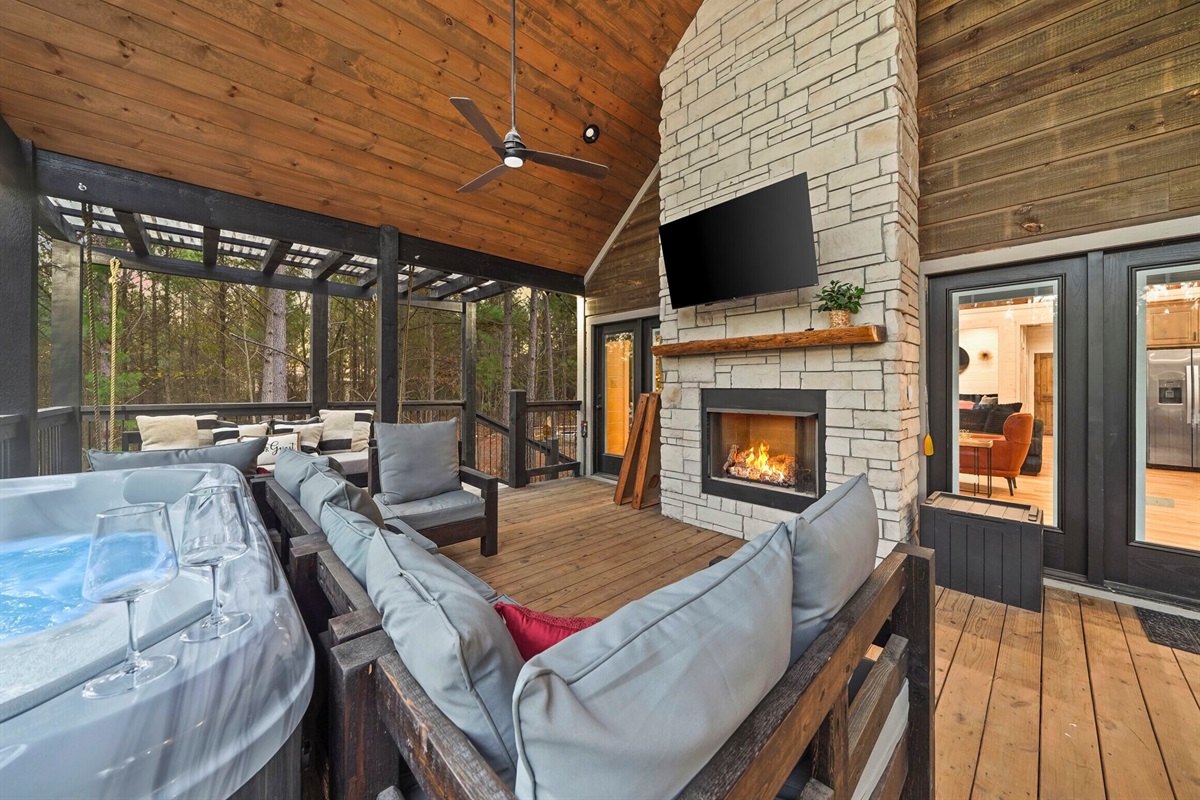 Outdoor living area with fireplace and comfortable seating.