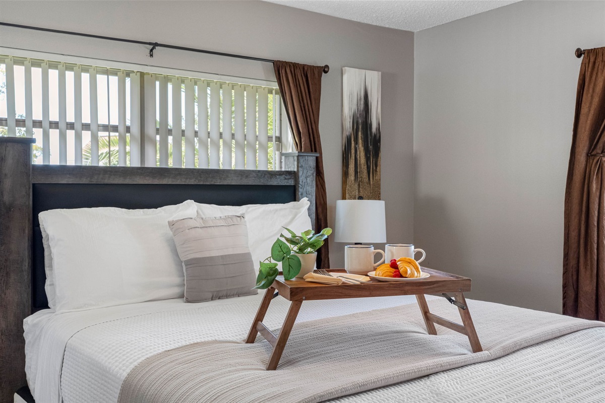 The cozy bed dressed in crisp white linens makes this space perfect for relaxation and restful sleep.