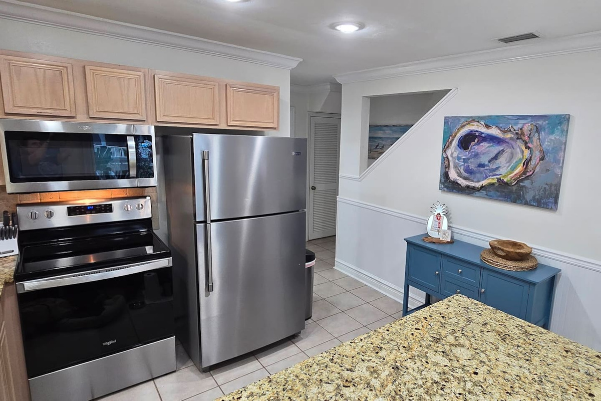 Cook a real vacation meal without fighting for counter space &mdash; the fully equipped kitchen has the spice rack, the Keurig, and everything else already waiting.