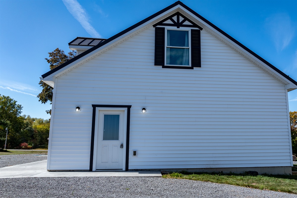 Charming farmhouse exterior with timeless appeal — your peaceful Finger Lakes escape begins here!