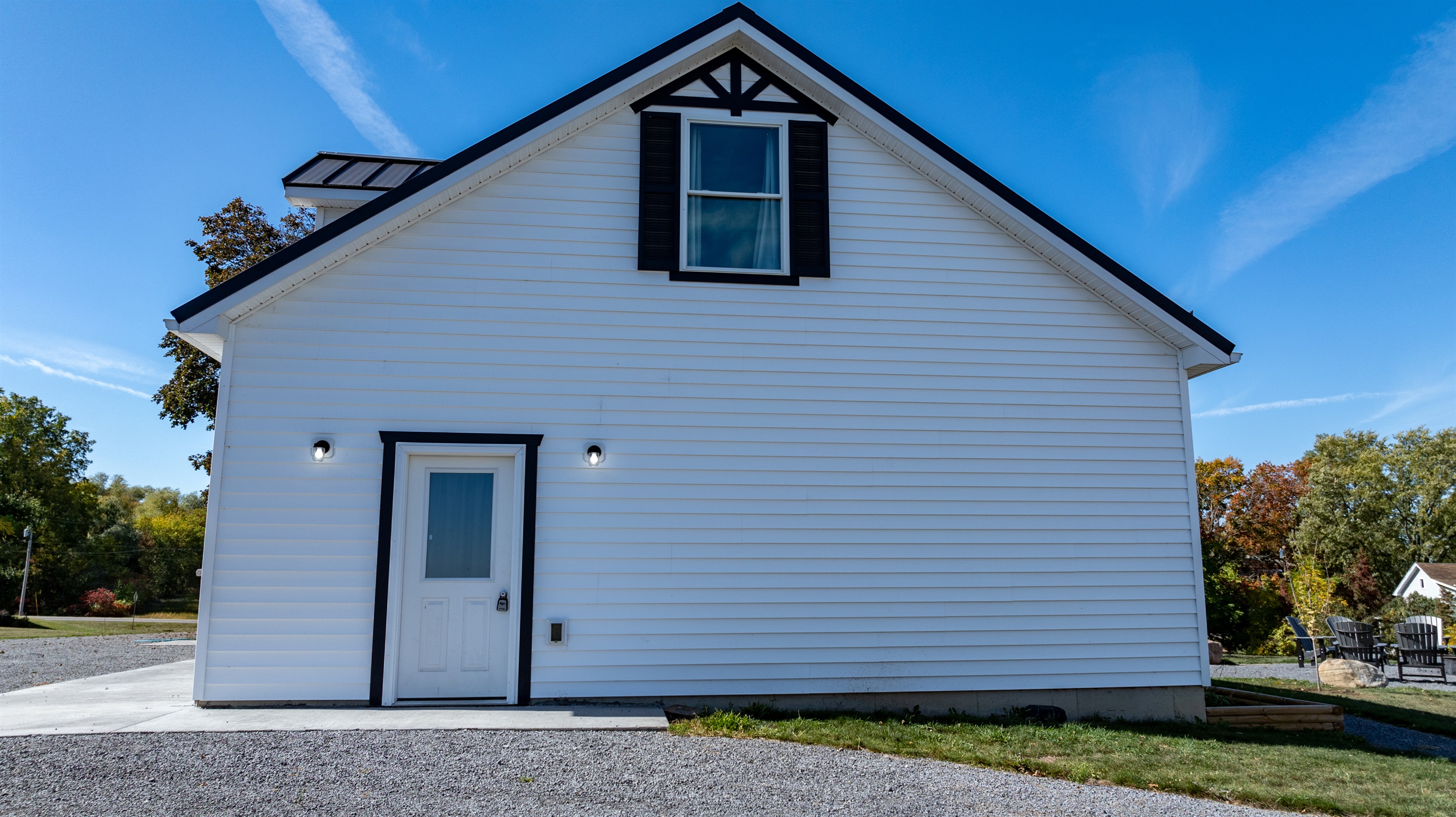 Charming farmhouse exterior with timeless appeal — your peaceful Finger Lakes escape begins here!