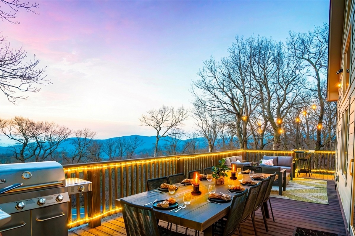 Twilight on the deck — mountains fading in the distance, wine glasses catching the glow of string lights, dinner sizzling on the grill. This is what gathering should feel like