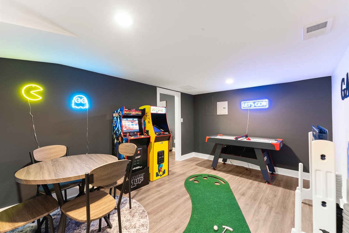 Game room with arcades, air hockey, giant connect 4, and putting green!