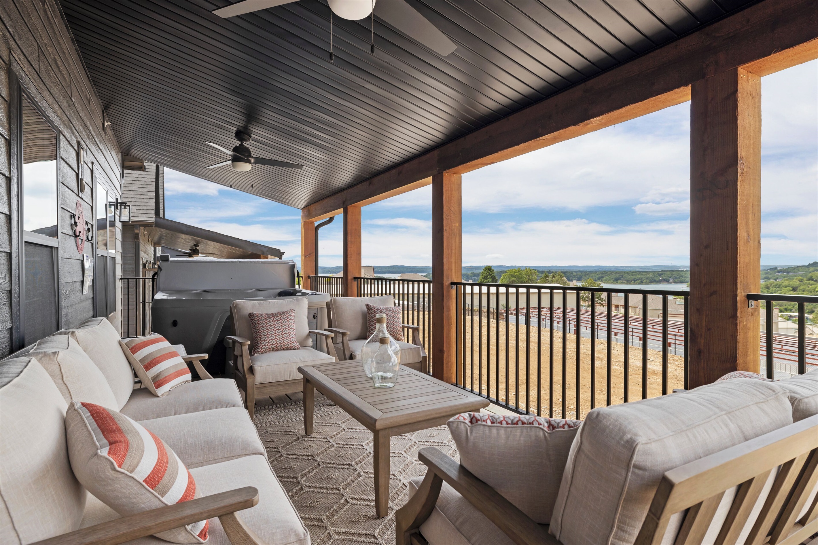 Main Level Deck with seating, hot tub, lakeview, and grill