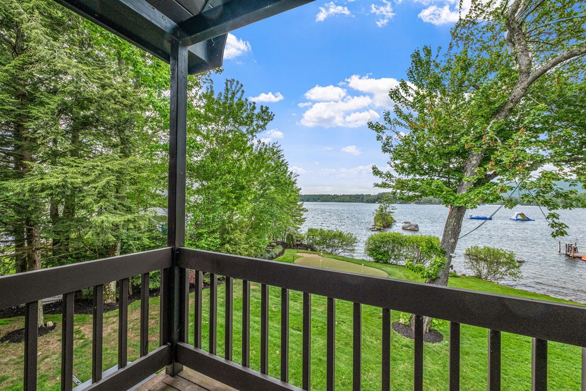 Second floor ensuite bedroom with king bed, balcony overlooking lake and its own full bath
