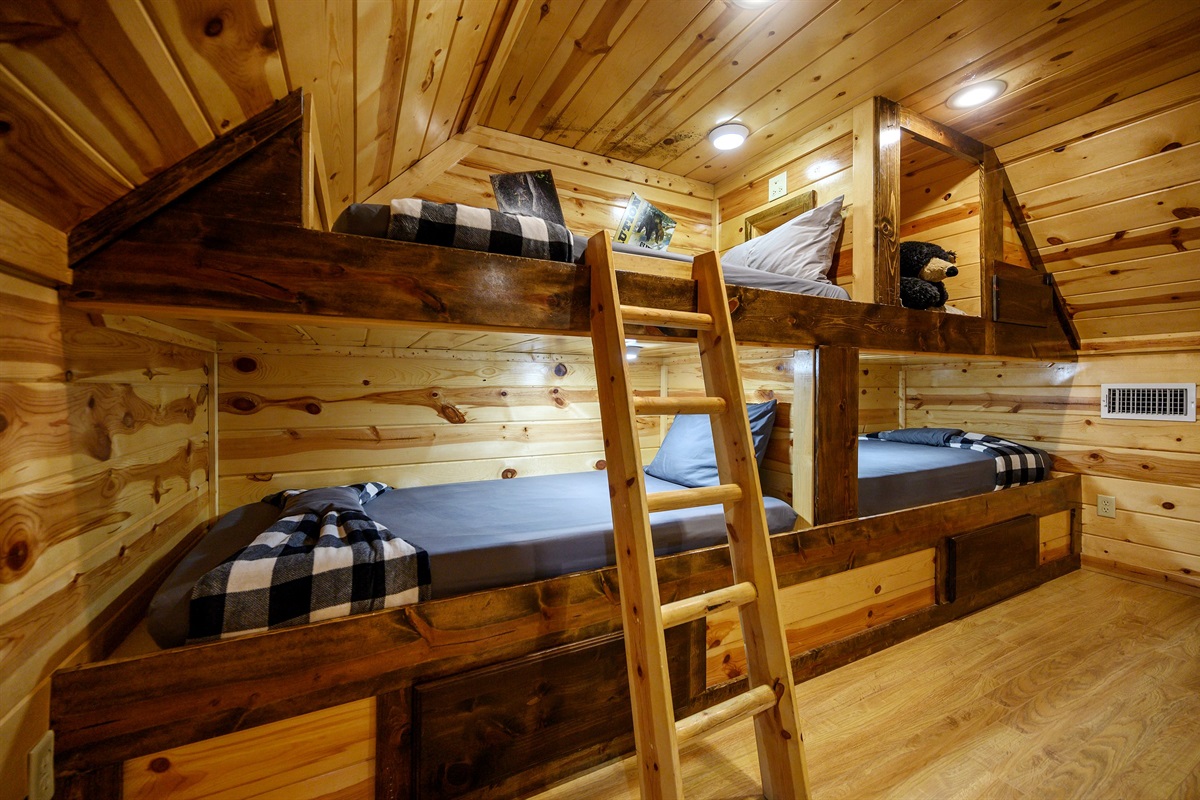 3 twin bunks with reading lights and drawers for storage.