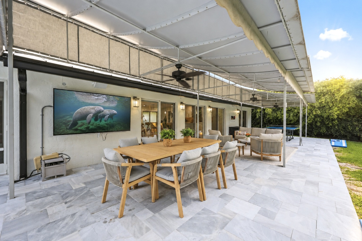 Play ping-pong, relax on the covered patio, or wander toward the canal and pool from this comfortable outdoor living space.
