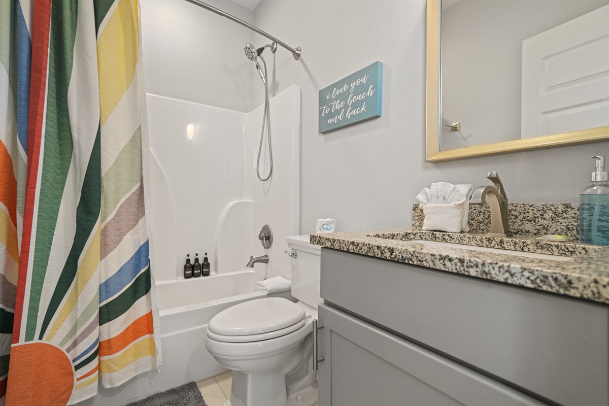 Double Queen Suite ensuite bathroom with granite vanity and shower/tub combination.