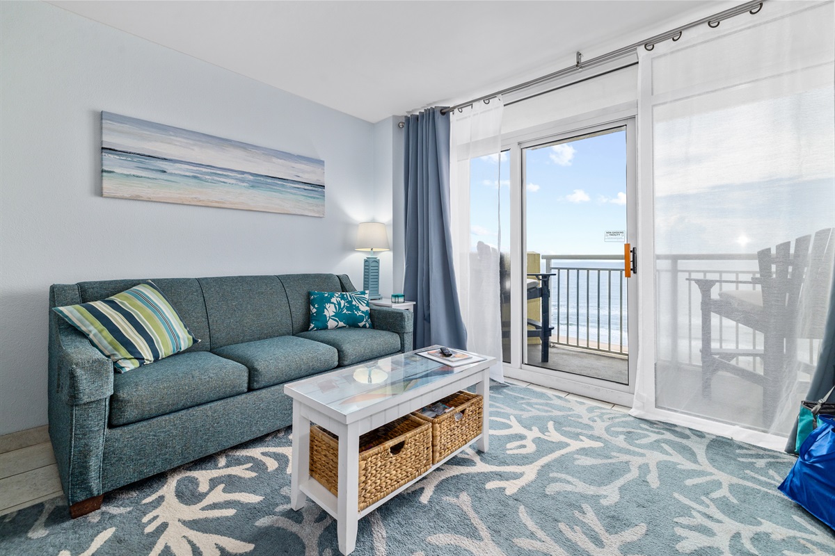 Settle into the cozy living area where a plush sofa faces the flat-screen TV — perfect for movie nights, game days, or catching up on your favorite shows after a day in the sun.