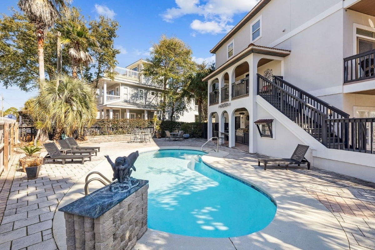 Pool area has a dolphin fountain water feature