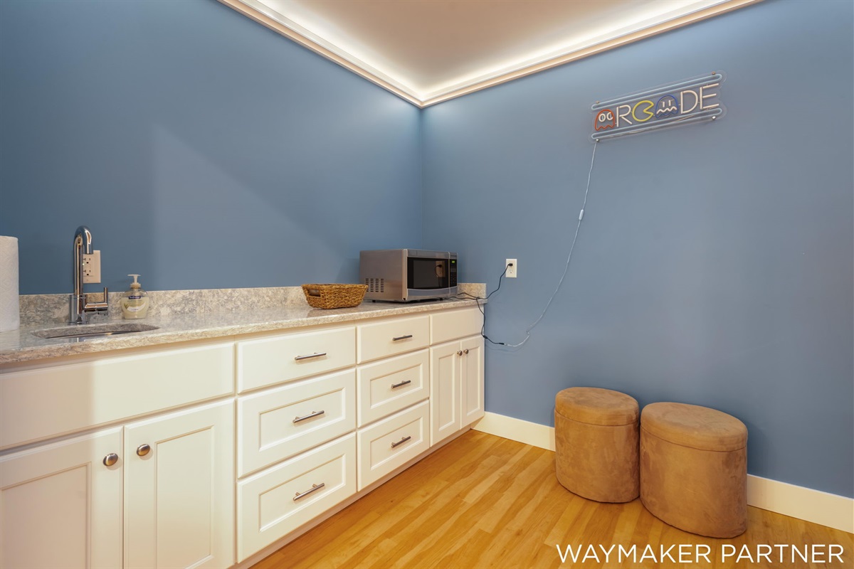 There is a microwave and popcorn in the arcade room to enjoy.