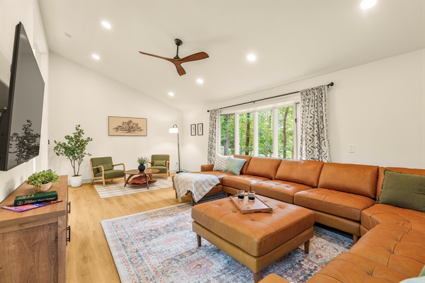 Gorgeous bay windows fill the living room with natural light. Sign into your accounts on the 75" TV and watch your favorite shows amidst the treetops!