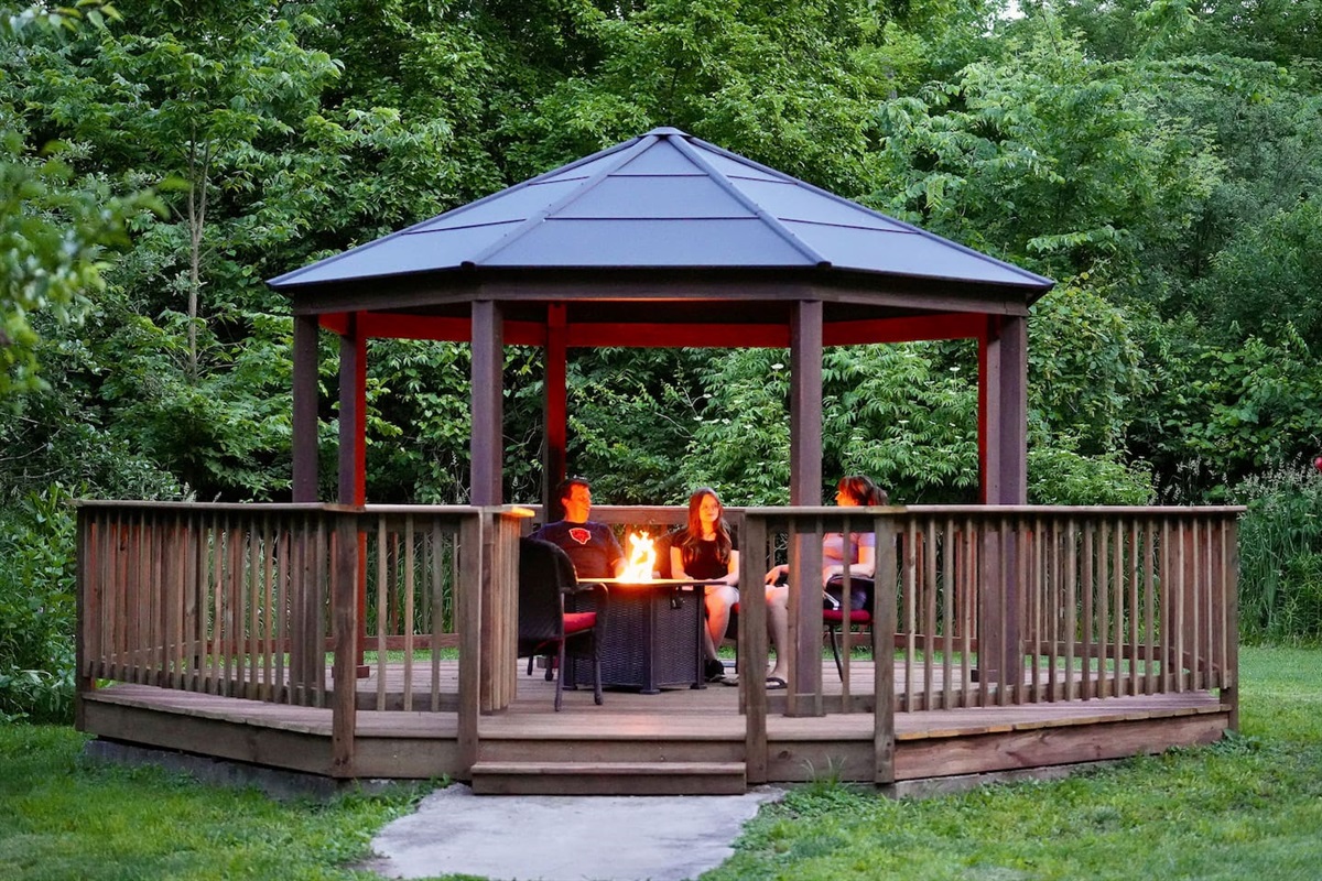 Bask in the warm glow of the fire table in the gazebo in the evening.