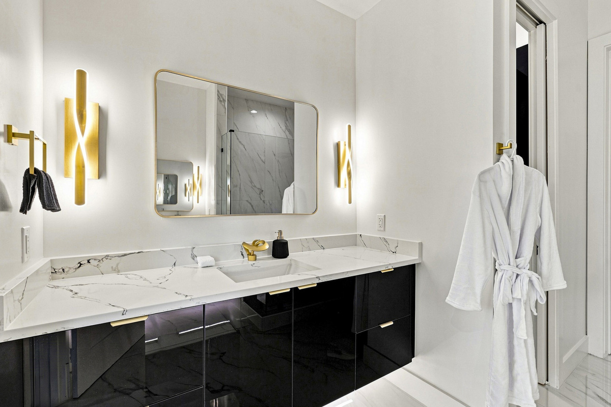 Experience elegance with chic decor and modern fixtures in this stunning bathroom!
