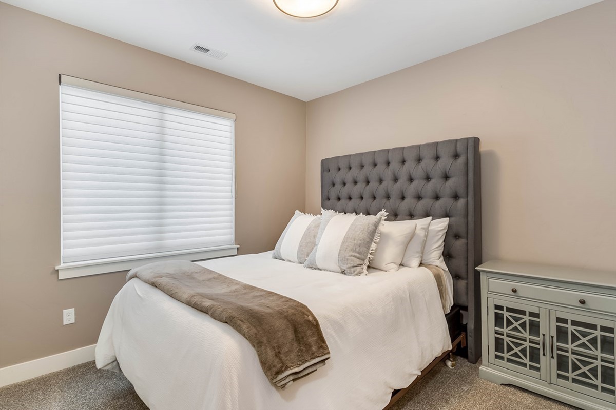 This queen bedroom offers comfort and privacy