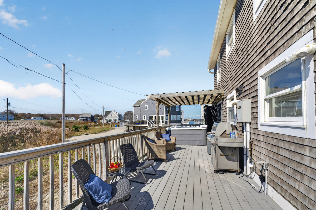 Spacious outdoor deck with comfortable seating, perfect for enjoying fresh air and coastal views.