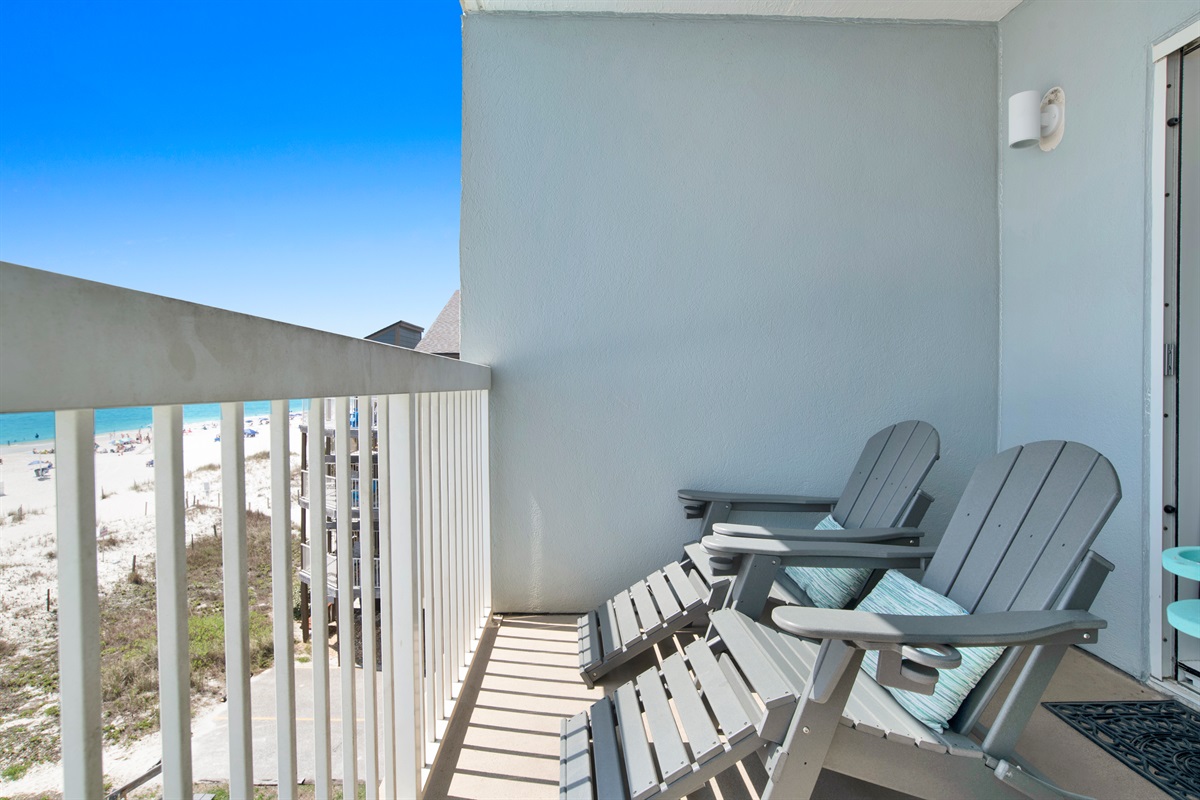 Private beachside balcony with seating and table