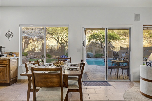 Open concept kitchen and dining table with amazing backyard mountain view oasis