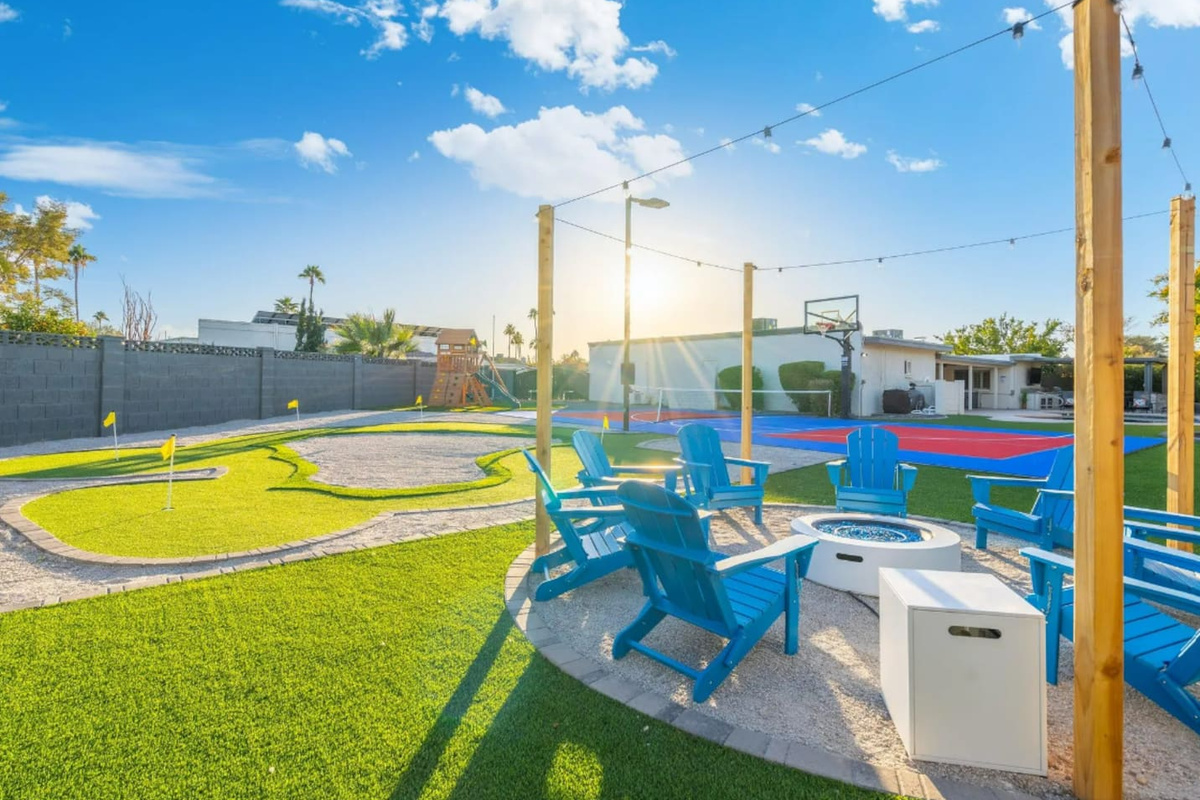 Golden hour hits just right here, with the fire pit and putting green sharing the same corner of the yard.