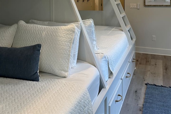 Spacious 2nd level twins over queens bunk room with full ensuite bathroom, tiled shower with tub, and a large vanity.