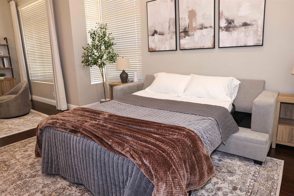By night, the sofa pulls out into a Queen size bed with a comfortable memory foam mattress.