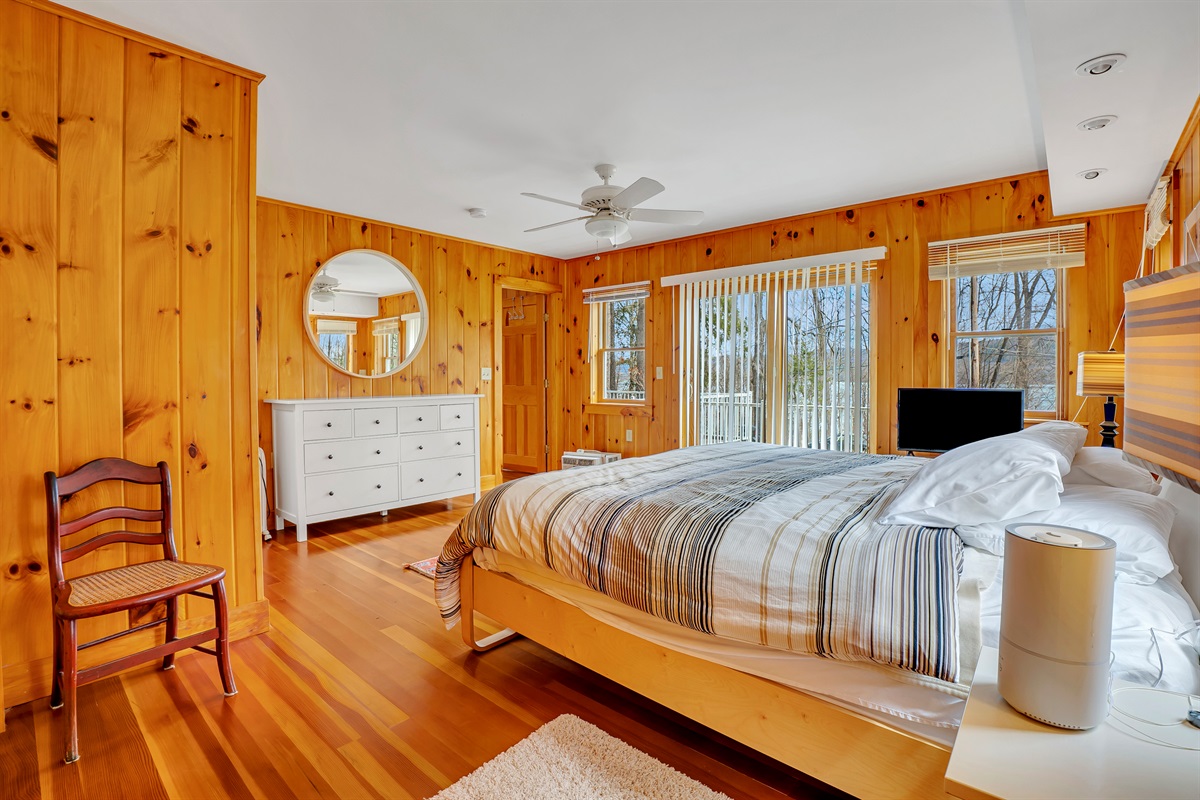 King primary bedroom with deck access and ensuite bath