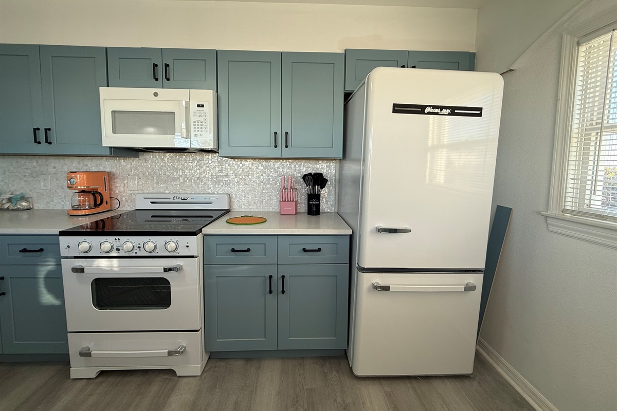 Blue Kitchen Cabinets with Retro Appliances and Mother of Pearl Backsplash!