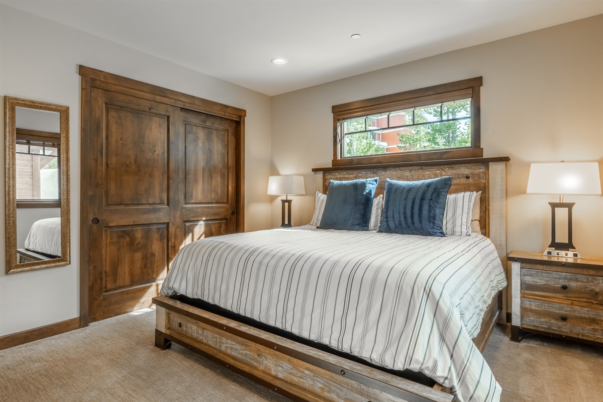 With an attached bath and generous light, this second primary bedroom ensures comfort and privacy for couples or additional adult guests.
