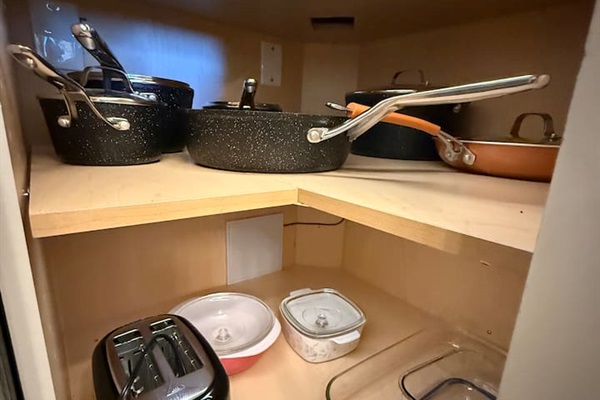 Cookware Storage: Dedicated shelving for the full set of quality pots and pans provides easy access for all your culinary needs.