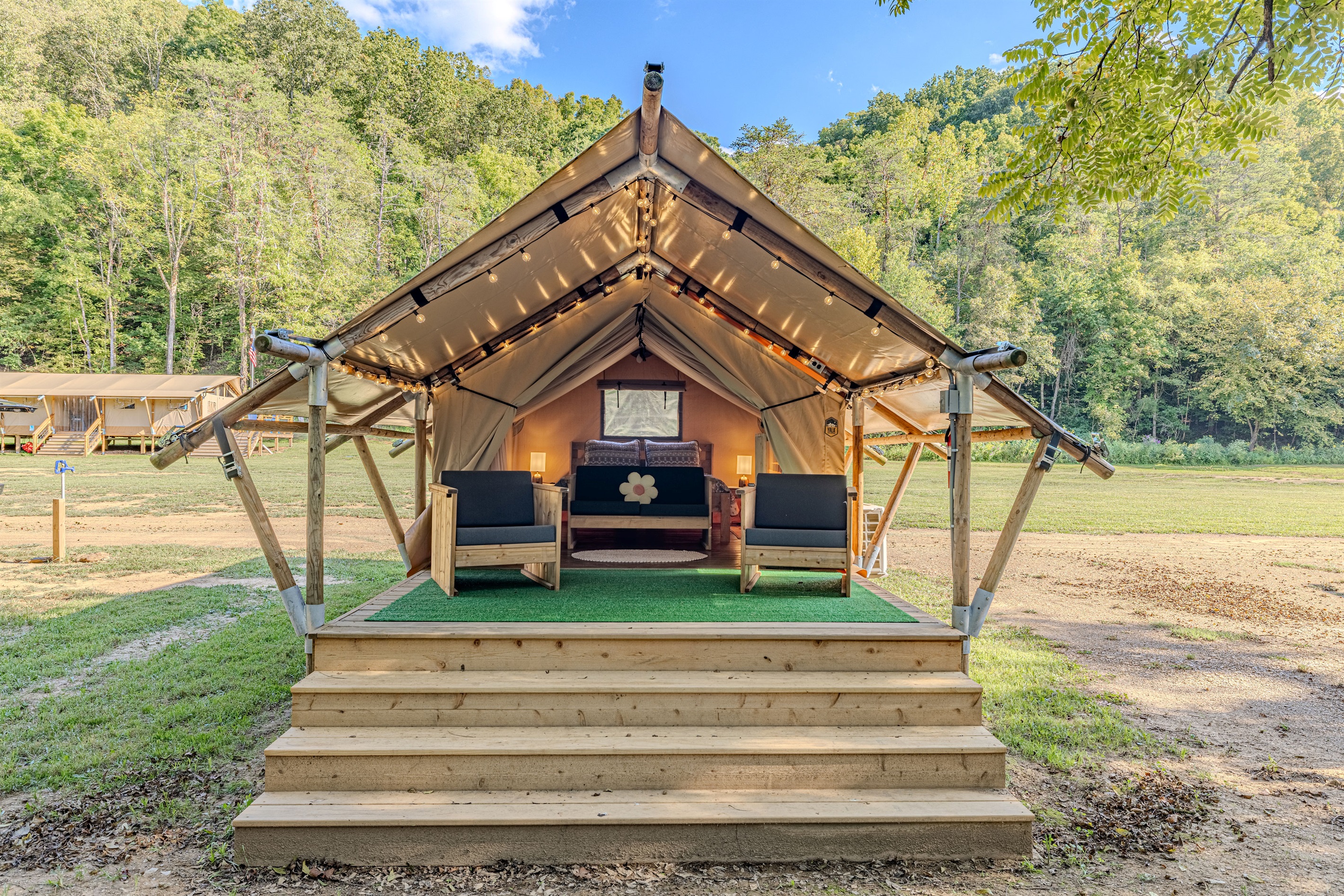 Welcome to Sagittarius! Your home away from home. Step up to your luxury tent, where a queen bed awaits behind a spacious deck perfect for morning coffee and enjoying the sounds of nature.